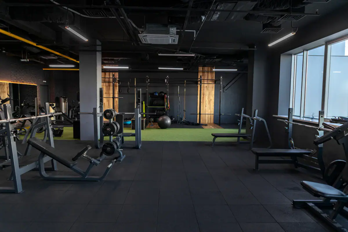 Dark empty gym interior with sports equipment in the morning, the type of space a school gym rental might offer