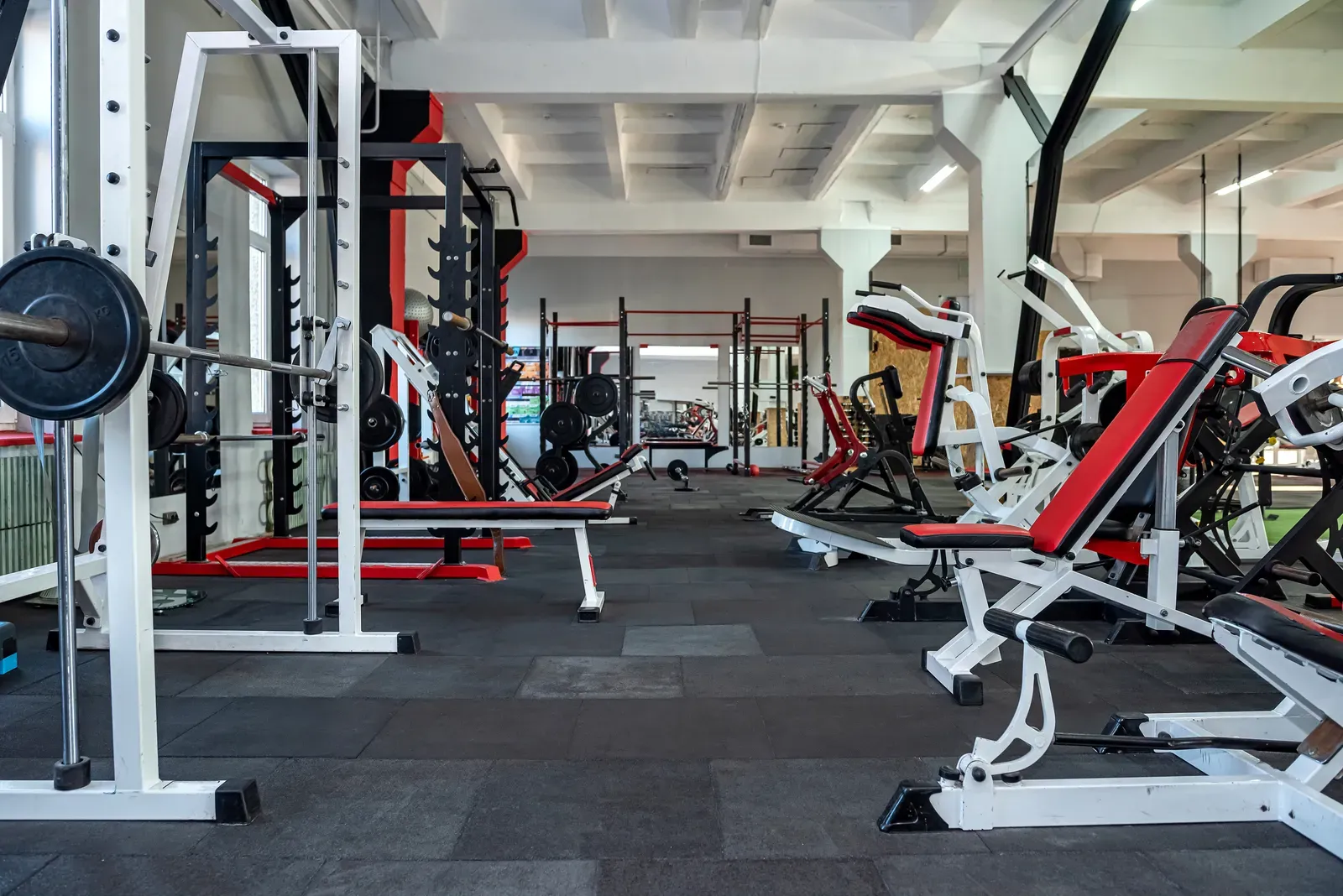 High school athletes training with barbells in a school weight room