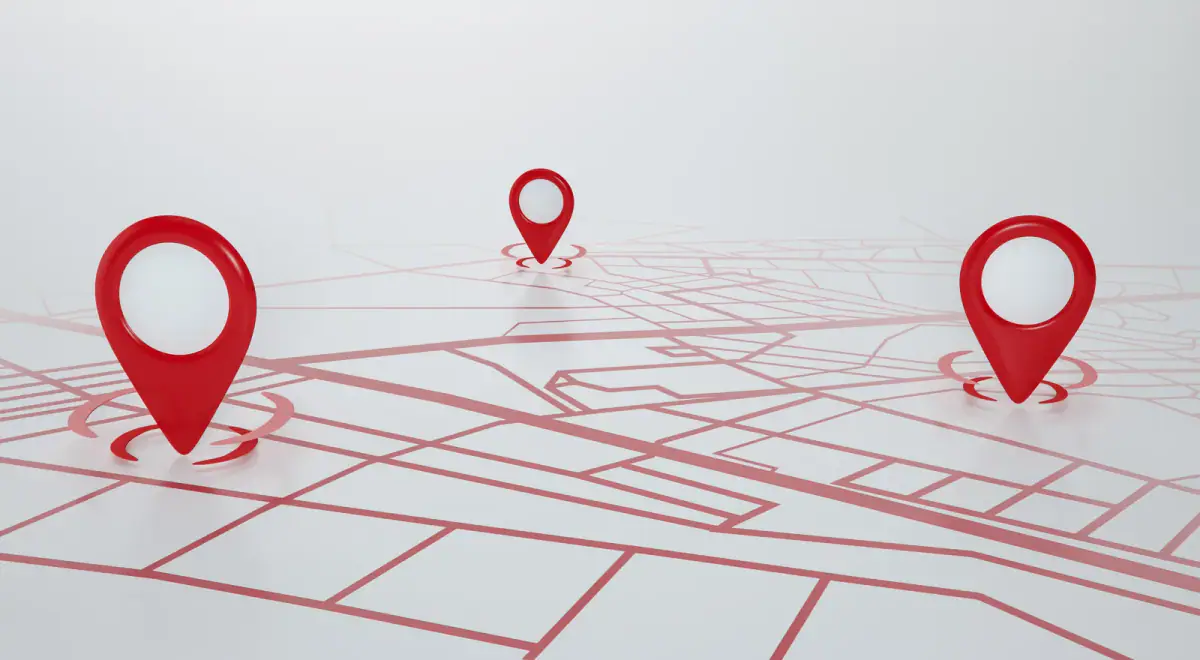Red location pins standing on a stylized street map