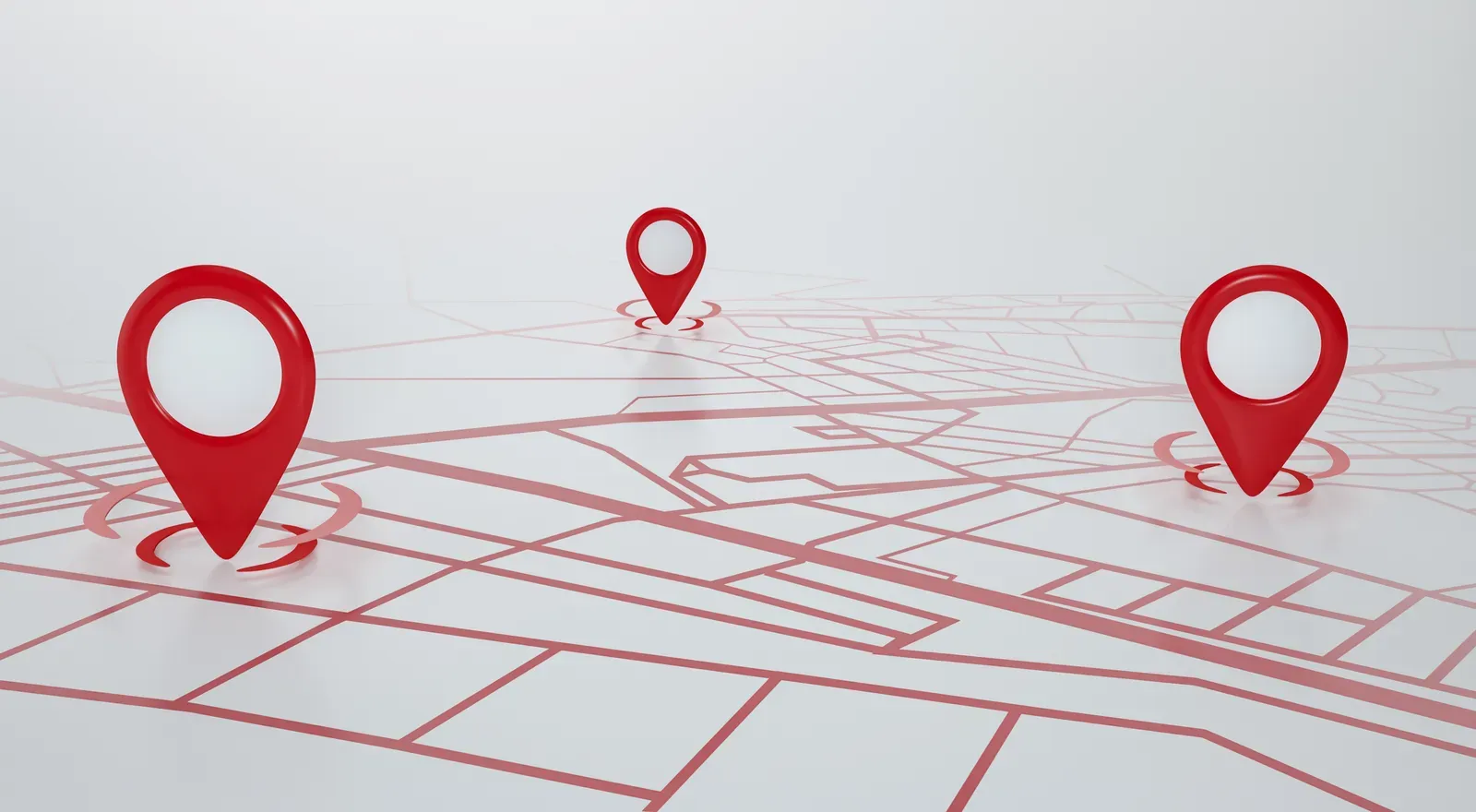 Red location pins standing on a stylized street map
