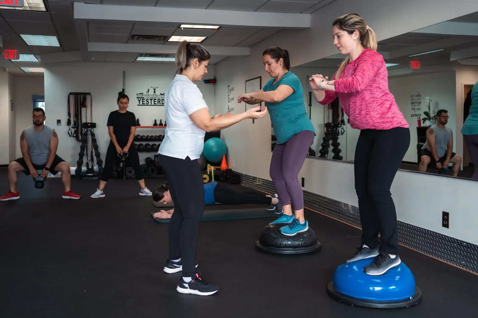 Several gym members working out at the same time on a shared floor