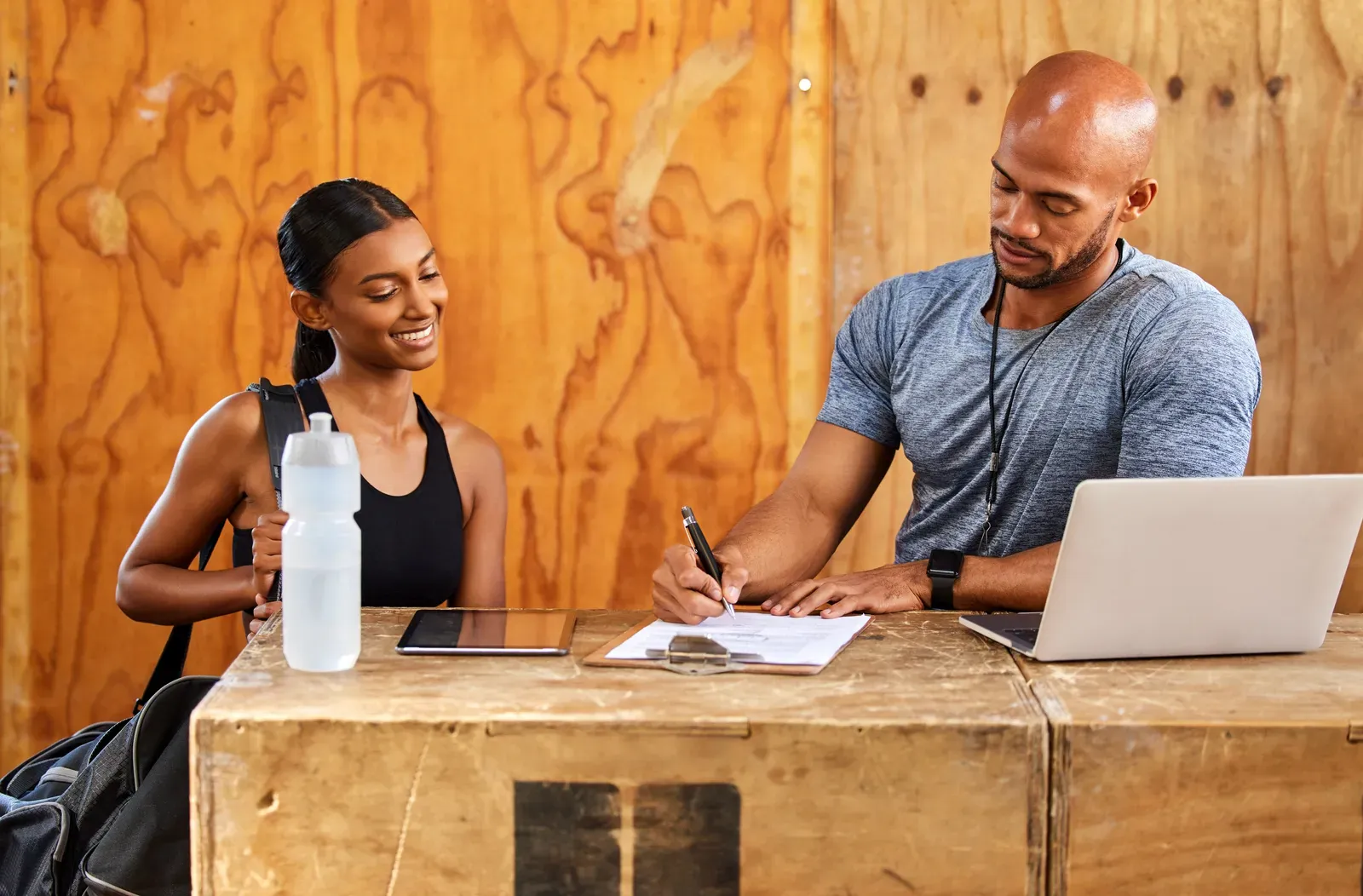 Person reviewing a gym contract and pricing sheet before signing