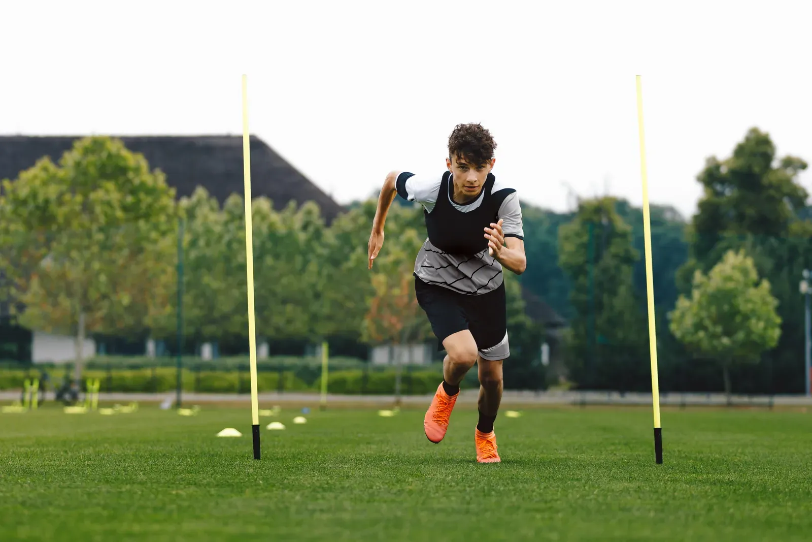 Young athlete training under a coach's direction in a small gym