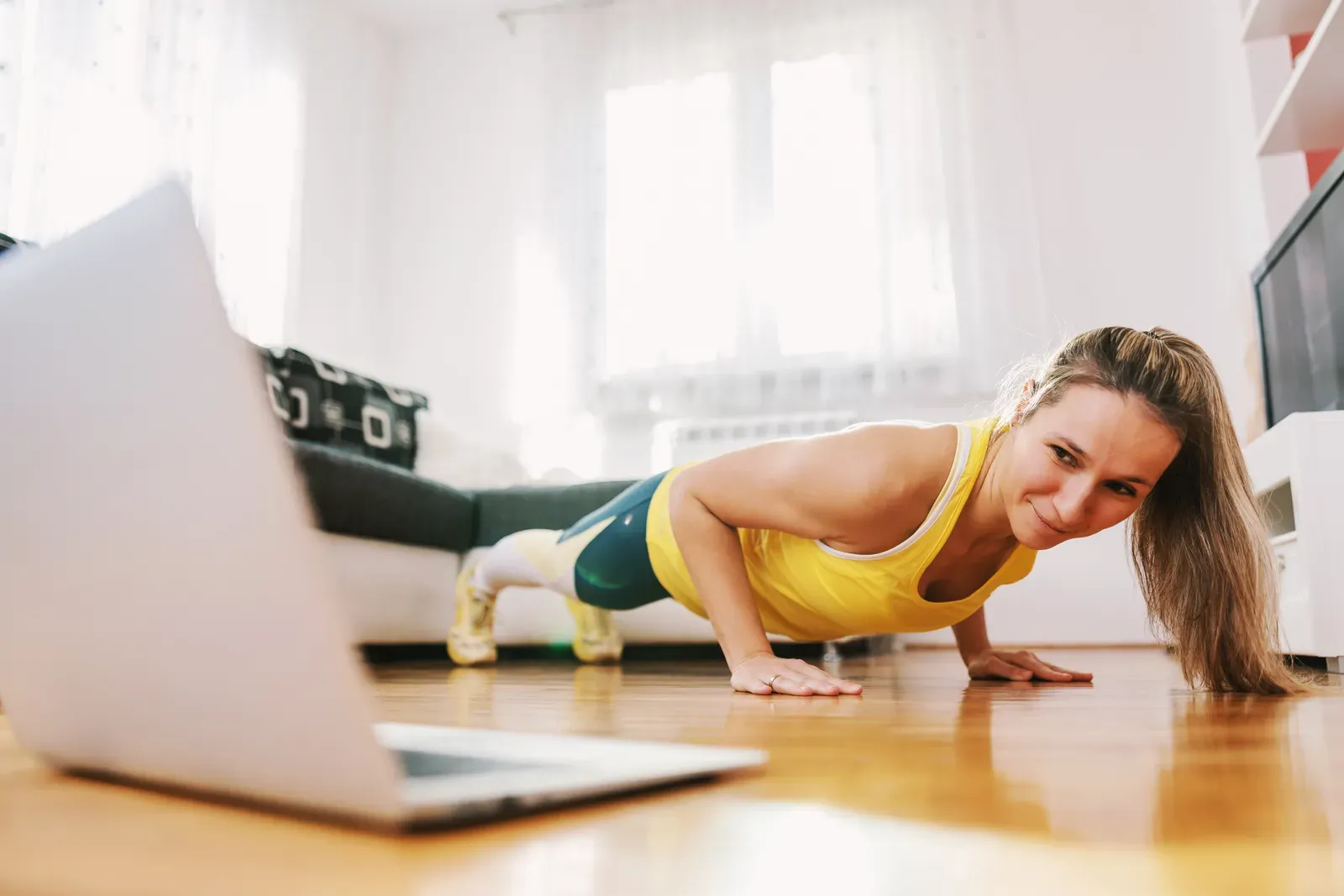 Fitness instructor teaching a live online class in front of a camera