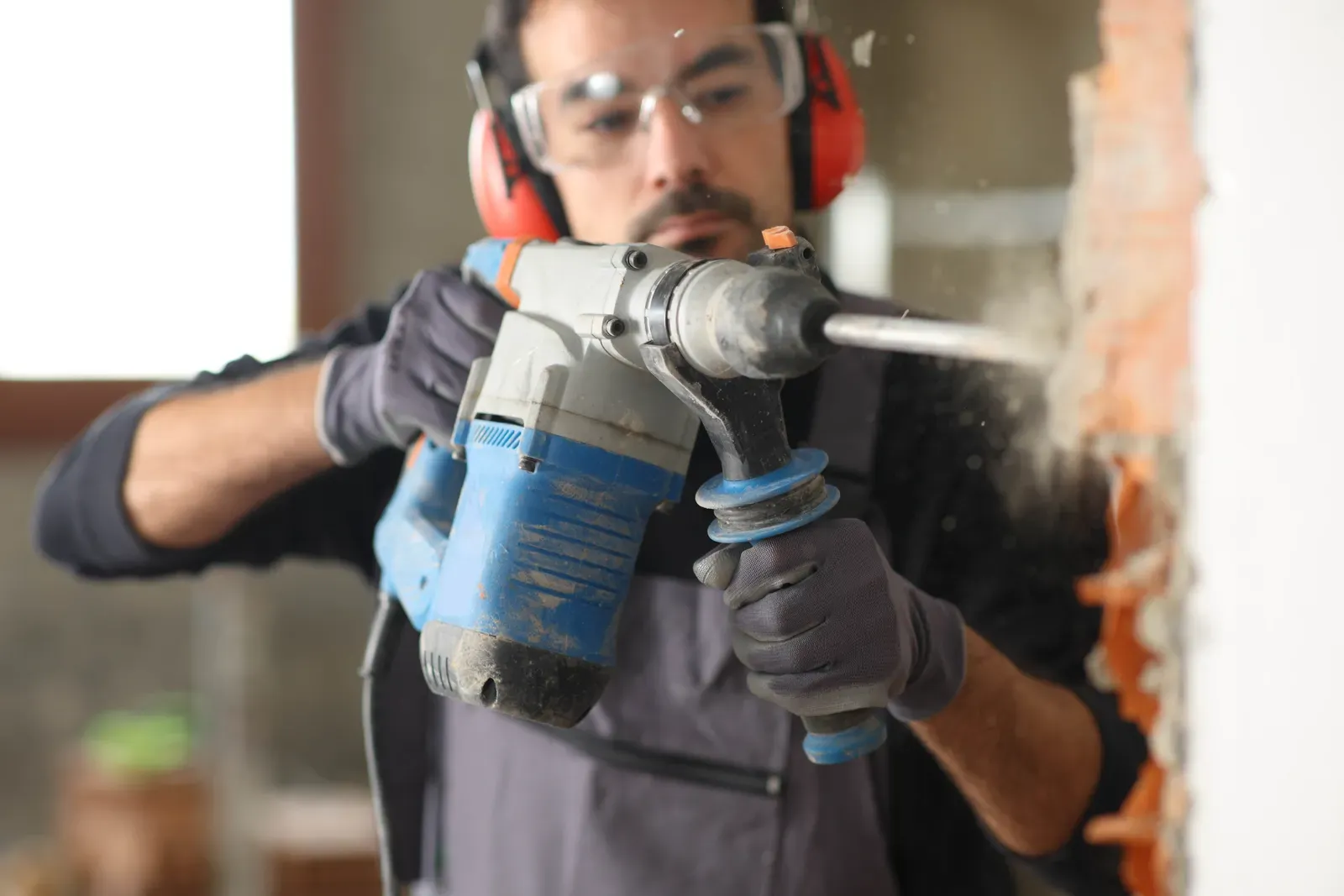 Home renovation in progress with tools and dust sheets covering a room
