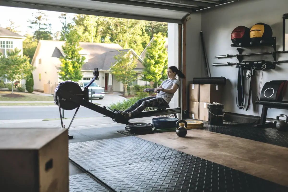Rowing machine session underway in a home garage gym