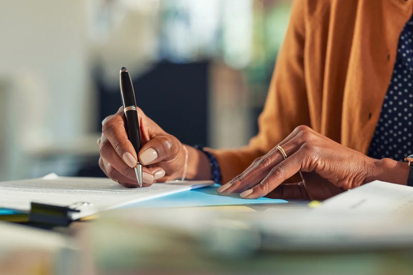 Writing out pricing options by hand at a desk, sessions versus packages
