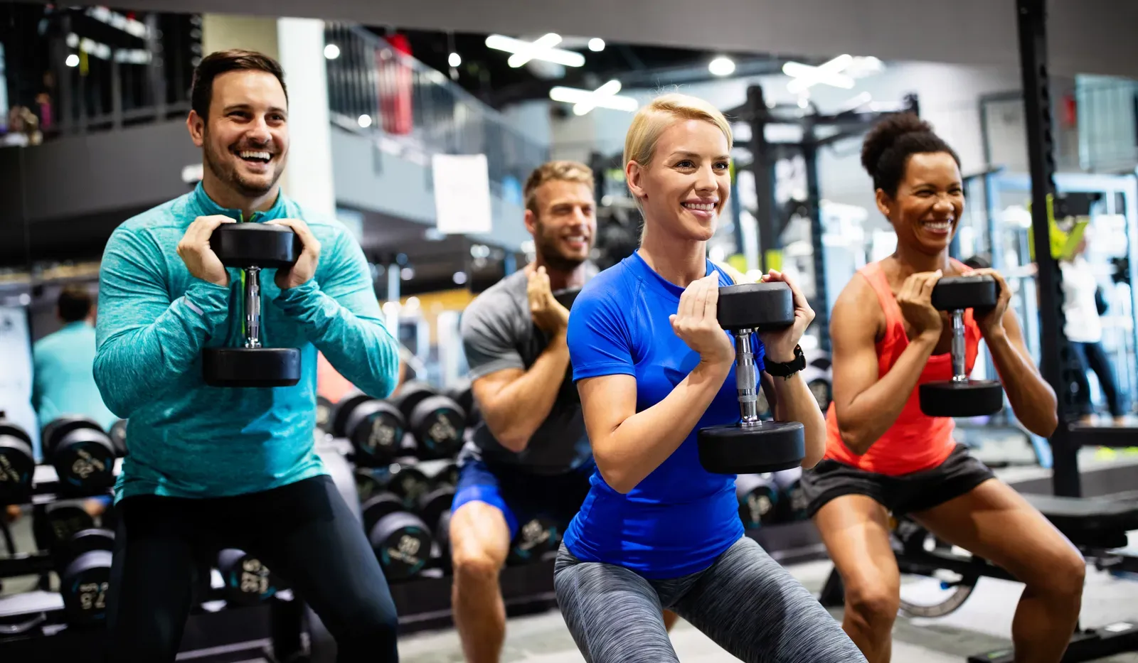 Group of athletes lifting weights together during a team training session