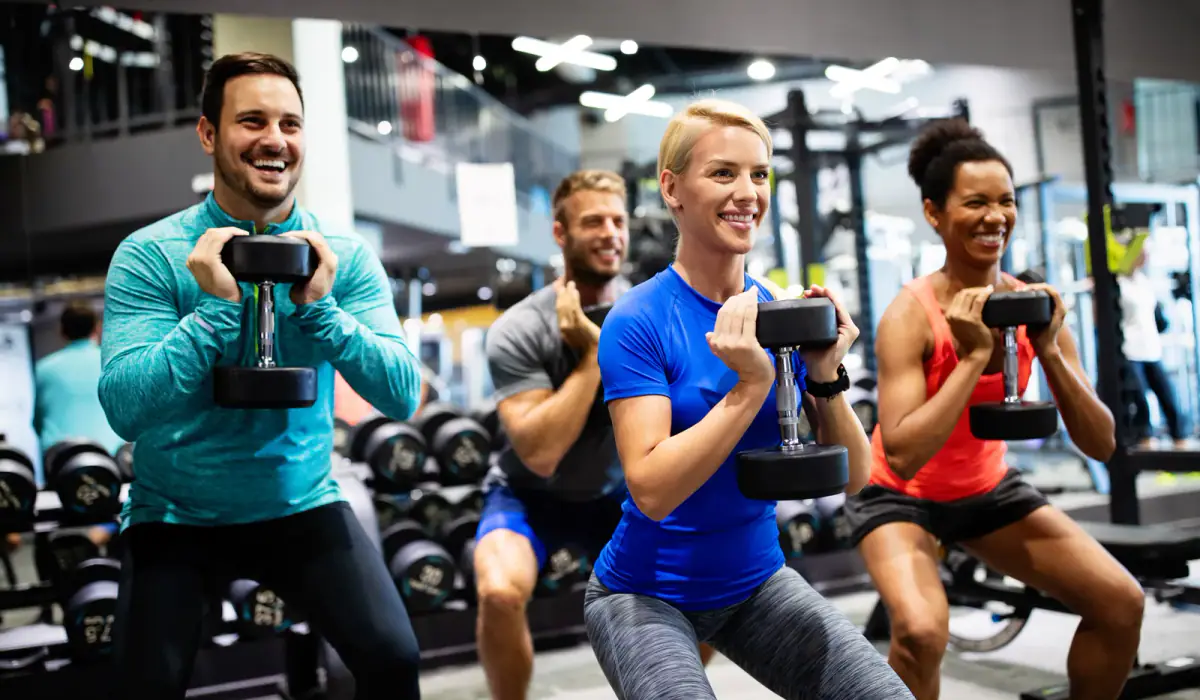 Group of athletes lifting weights together during a team training session