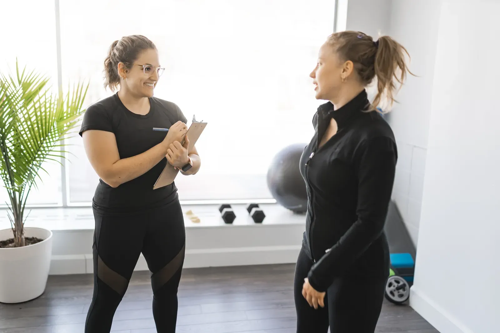 Personal trainer coaching a client through a training session