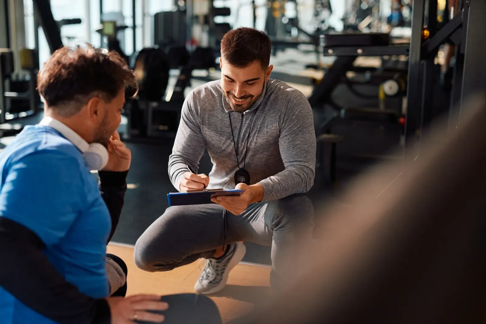 Trainer and client working out together in a city gym