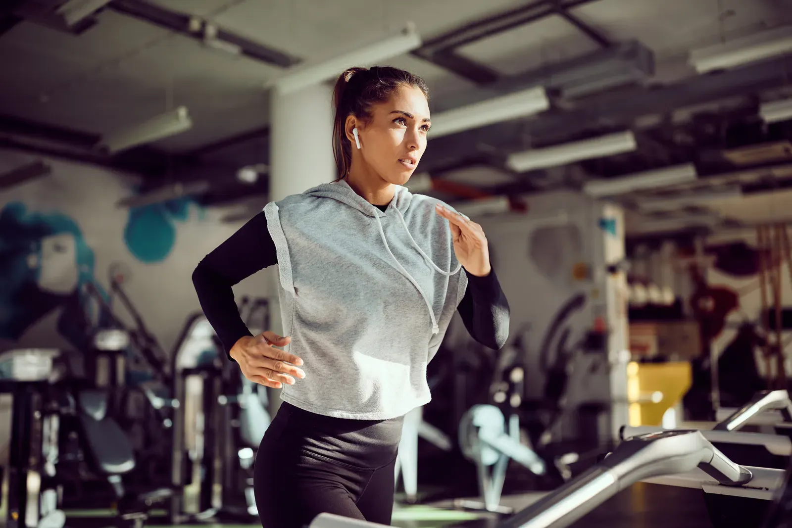 Runner holding a steady tempo on a treadmill while winter light comes through the window