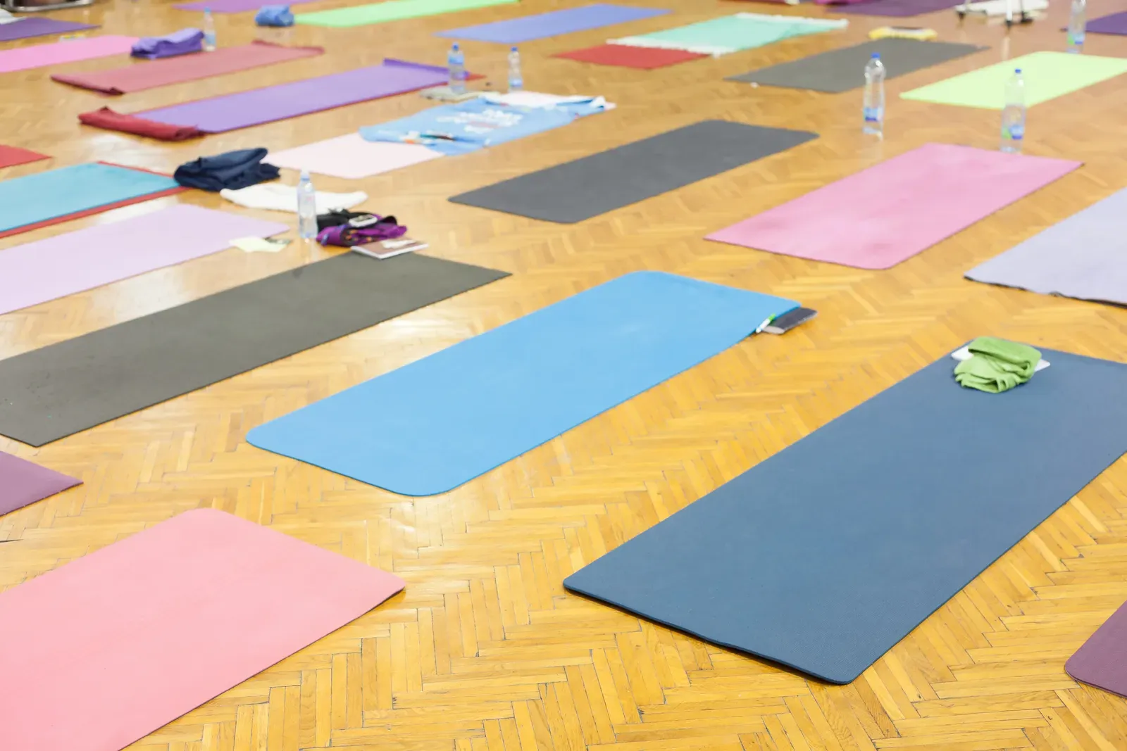 Empty yoga studio with warm light falling across a wood floor