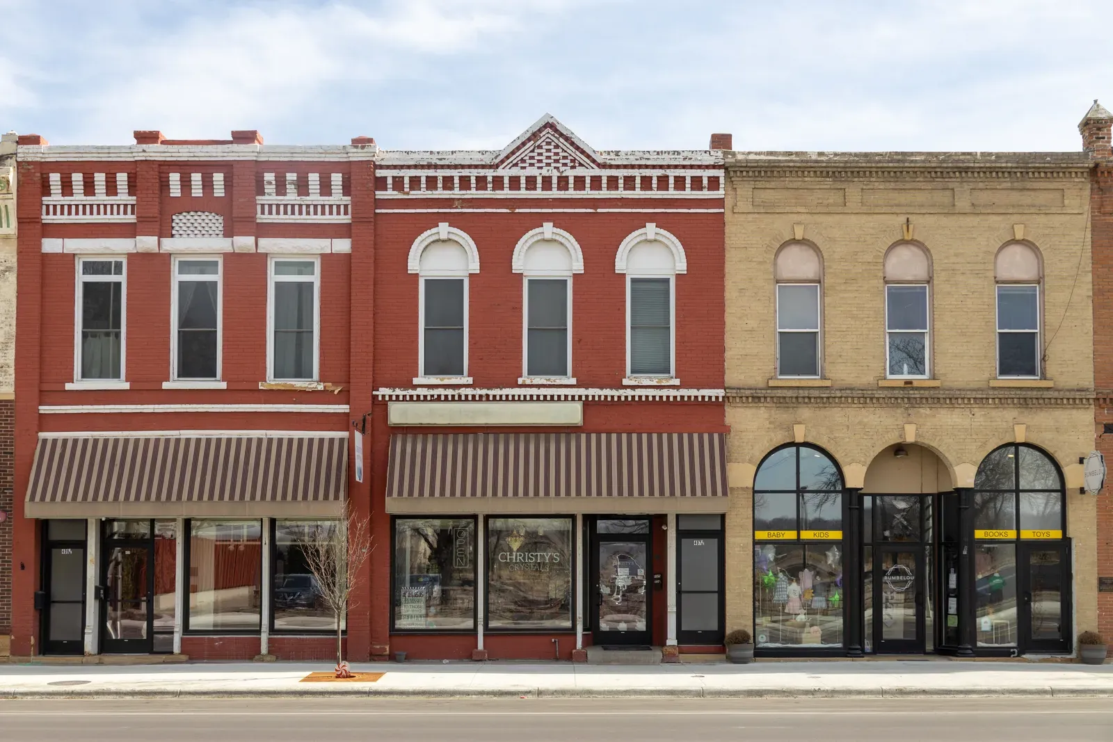 Row of historic brick storefronts along a small town main street
